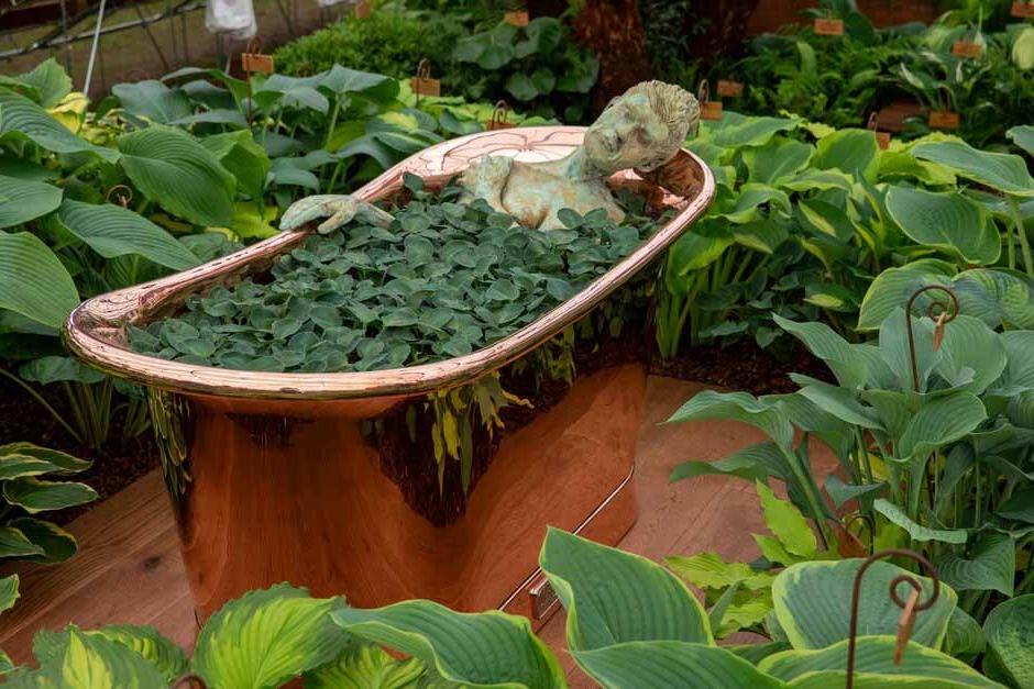 Statue of a lady in a bath on New Forest Hostas & Hemerocallis display