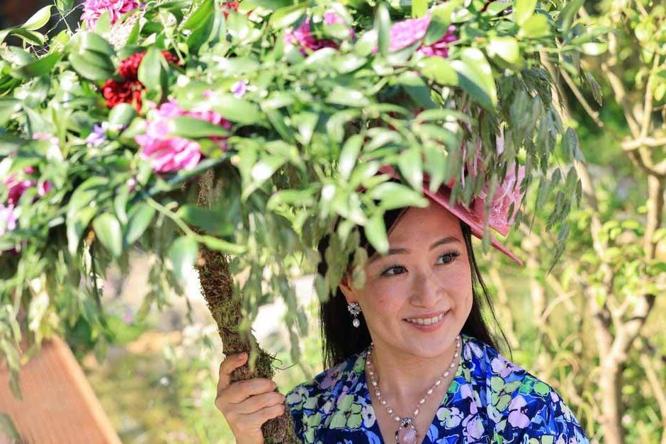 Visitor takes shade beneath a floral parasol